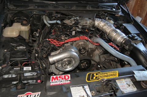 1985 Mercury Grand Marquis - The engine bay features a turbocharger and various aftermarket performance parts.