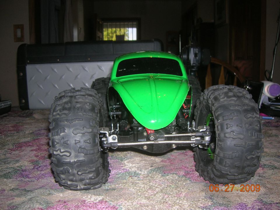 Green RC car with large tires, front view