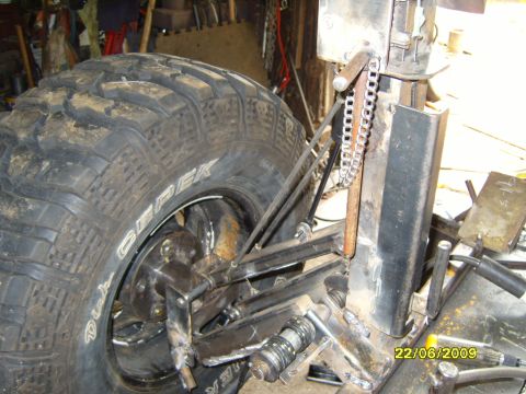 1989 Ford Bronco - Close-up view of a vehicle's rear suspension system and a large off-road tire. The registry claims this is a 1989 Ford Bronco, but the imag…