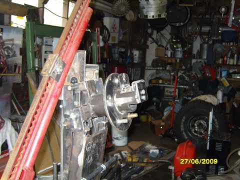 1989 Ford Bronco - Workshop scene with tools, a jack, and a spare tire, dated 27/06/2009.