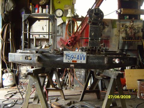 1989 Ford Bronco - A custom-fabricated bumper is mounted on sawhorses in a workshop setting, a license plate.