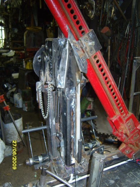 1989 Ford Bronco - Custom fabricated part with a red hi-lift jack attached, seen in a workshop.
