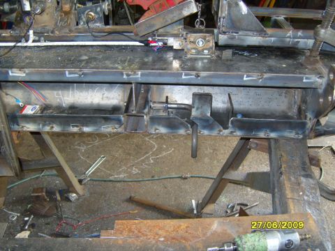 1989 Ford Bronco - This photo shows a section of a metal frame, likely under construction or repair, with visible welding and electrical components.