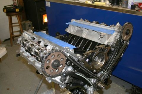 2007 Ford Mustang - Engine assembly on a stand, with timing chains and camshafts visible.