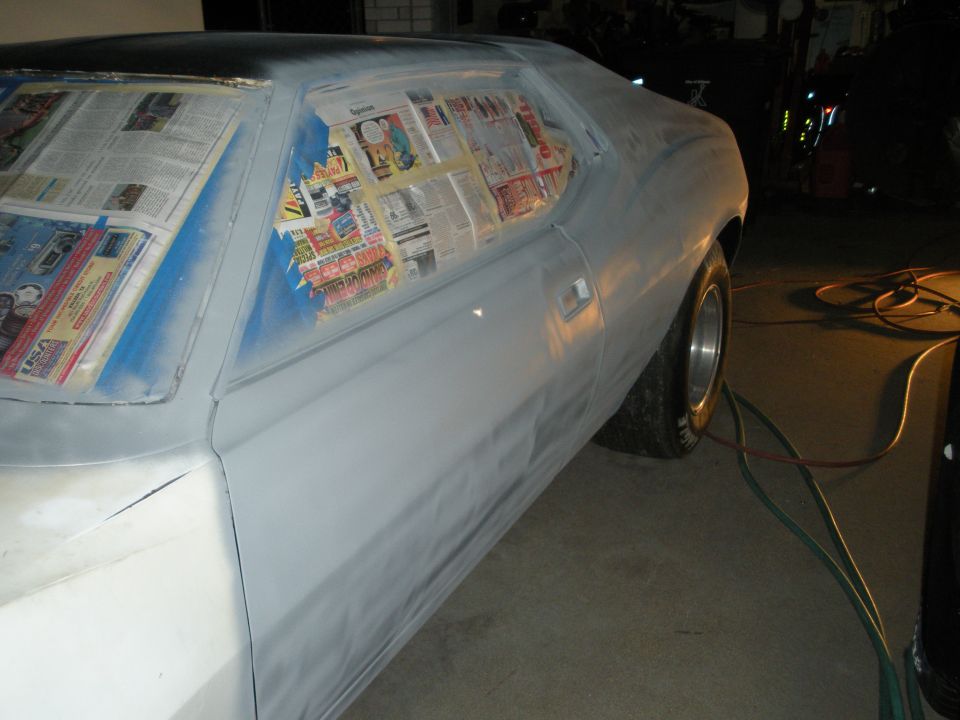 AMC Javelin with windows taped off for paint prep. Looks like it's getting ready for a new coat