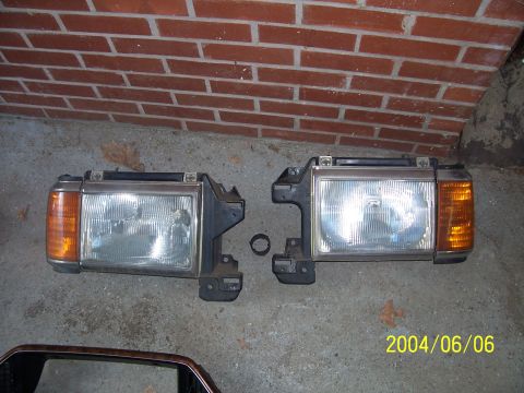 1990 Ford Bronco - A pair of headlights, likely for a 1990s era vehicle, are displayed on a concrete floor.