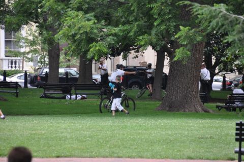 1996 Ford Bronco - Several individuals, some in uniform, are present in a park setting with trees and benches.