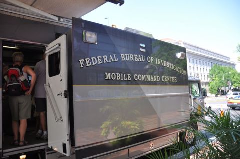 1996 Ford Bronco - The side of a Federal Bureau of Investigation Mobile Command Center truck is visible, with an open door and people walking inside.