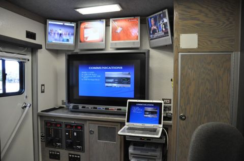 1996 Ford Bronco - The interior of a command vehicle is equipped with multiple screens and electronic devices for communication and monitoring.