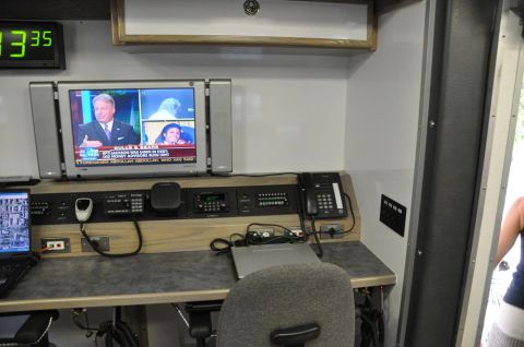 1996 Ford Bronco - Interior view of a mobile command center with communication equipment and a television.