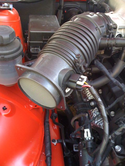 2010 Hyundai Genesis - Close-up of an engine's air intake system, with a visible Supermotors.net watermark.