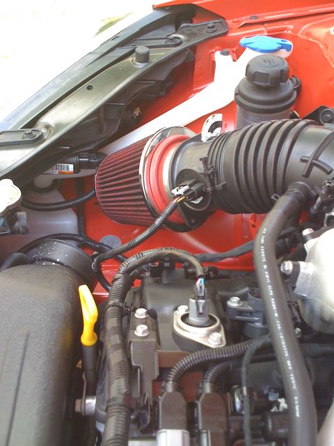 2010 Hyundai Genesis - Close-up view of a vehicle's engine bay, highlighting an aftermarket air intake system and various engine components.