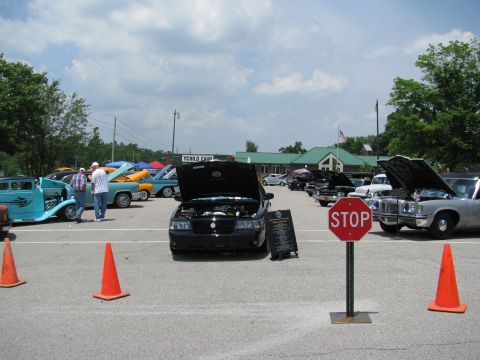 2003 Mercury Marauder - A black 2003 Mercury Marauder is displayed with its hood up at a car show, surrounded by other vehicles.