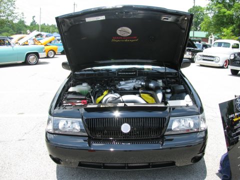 2003 Mercury Marauder - A black 2003 Mercury Marauder is displayed with its hood open, revealing the engine and a 'Marauder Supercharged' emblem on the underside o…