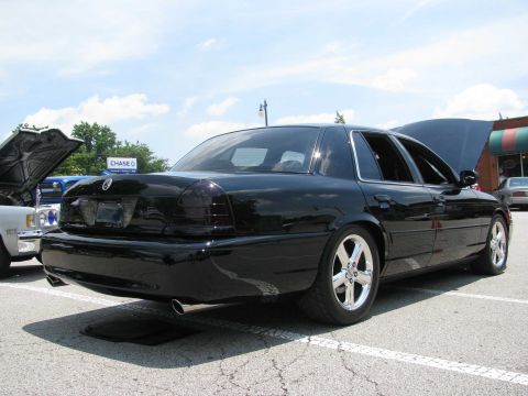2003 Mercury Marauder - A black 2003 Mercury Marauder is parked at an outdoor event with other vehicles.