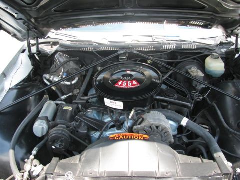 2003 Mercury Marauder - Engine bay detail showing air cleaner and fan shroud with caution sticker.
