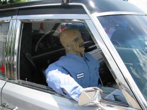 2003 Mercury Marauder - A mannequin wearing a blue shirt with a 'CORONER' patch is positioned inside a vehicle.