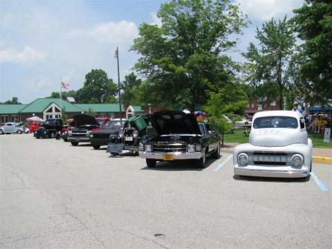 2003 Mercury Marauder - A line of vehicles are parked at an outdoor car show, with a white pickup truck prominently in the foreground.