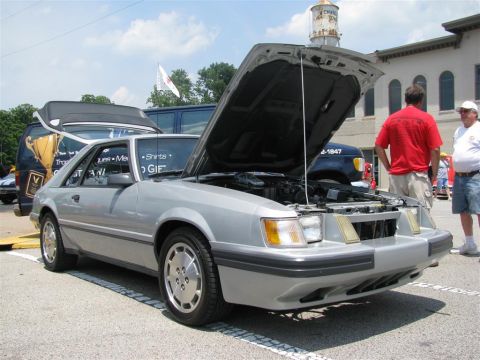 2003 Mercury Marauder - A silver third-generation Ford Mustang is displayed with its hood open at an outdoor car show.