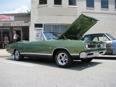 2003 Mercury Marauder - A classic green Dodge Coronet convertible is displayed with its hood up at an outdoor event.