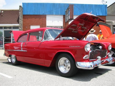 2003 Mercury Marauder - A classic red Chevrolet sedan is displayed with its hood open, revealing the engine compartment.