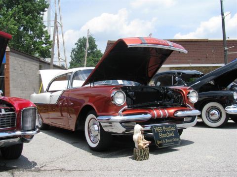 2003 Mercury Marauder - A 1955 Pontiac Starchief is displayed with its hood open at a car show.