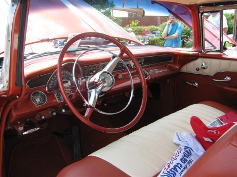 2003 Mercury Marauder - The interior of a classic car features a two-tone dashboard and seating, with a prominent steering wheel and chrome accents.