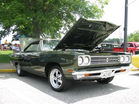2003 Mercury Marauder - A green 1970 Plymouth Road Runner is displayed with its hood open at a car show.