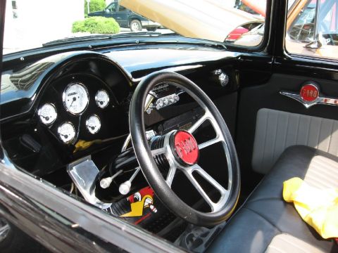 1966 Ford F-100 - The interior of a classic Ford F-100 truck features a custom steering wheel and updated gauges.