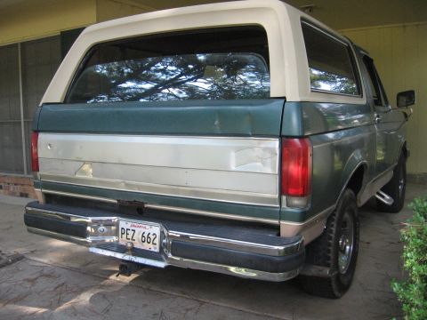 1989 Ford Bronco - Rear view of a 1989 Ford Bronco, showing its two-tone paint scheme and license plate.