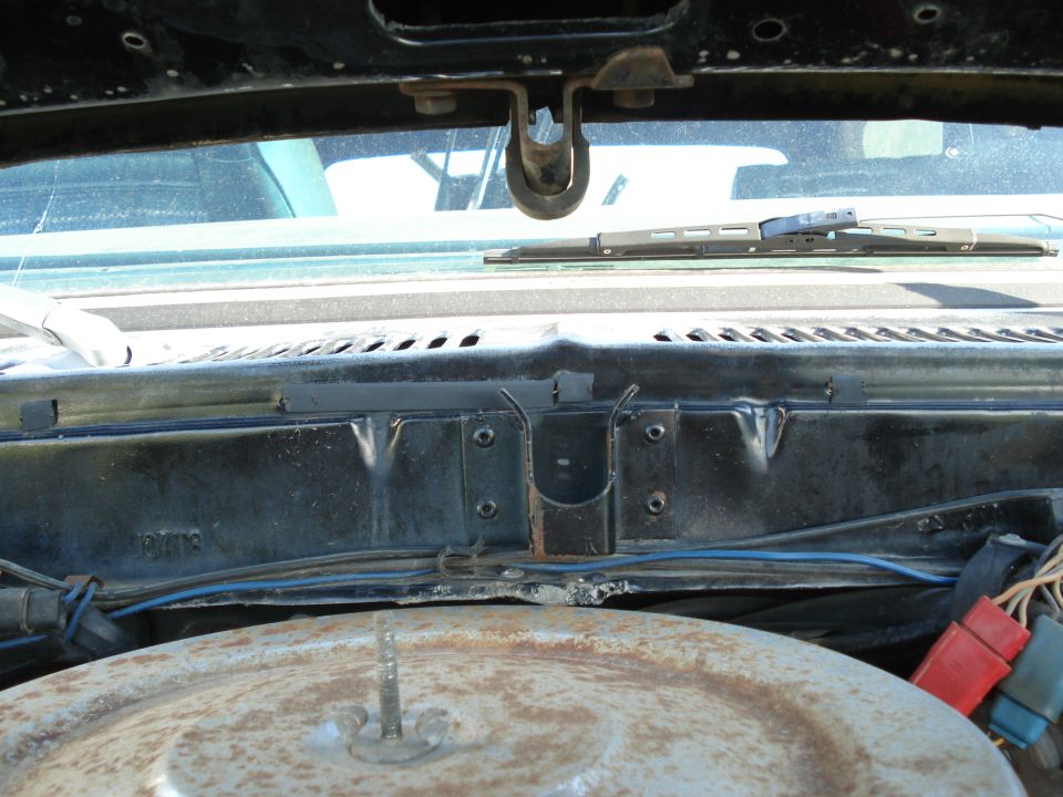 Under hood view showing windshield wiper assembly and part of the air cleaner housing