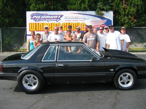 1992 Ford Mustang - Group poses with a black 1992 Ford Mustang at Piedmont Dragway's Winners Circle.