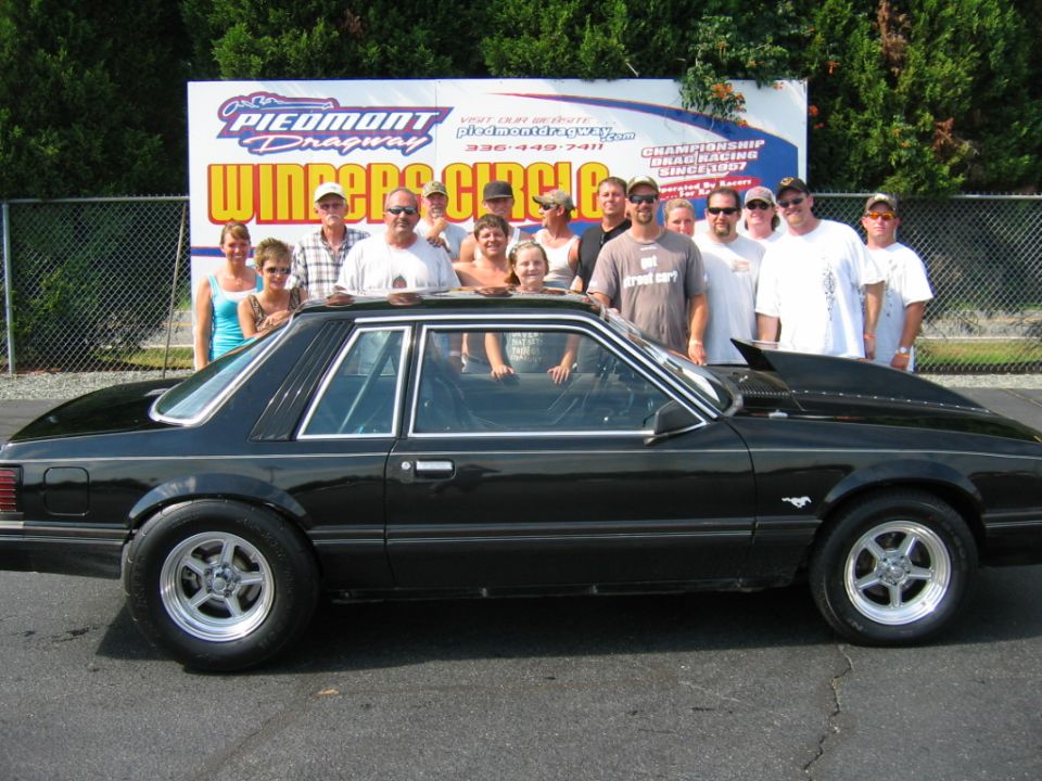 1992 Ford Mustang with a group of people standing behind it at Piedmont Dragway