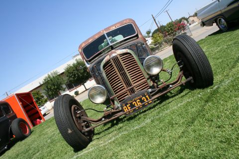 1984 Ford Bronco - This heavily rusted rat rod truck features an exposed front end and a California license plate.