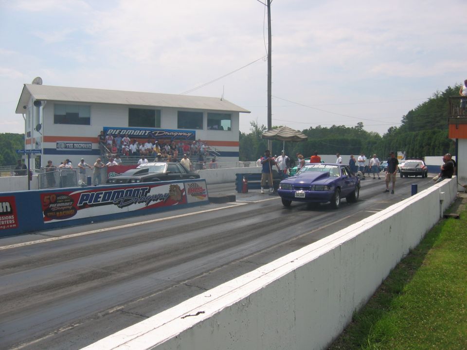 1992 Ford Mustang drag racing against another car at Piedmont Dragway
