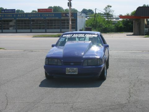 1992 Ford Mustang - This 1992 Ford Mustang features a prominent hood scoop and racing decals, indicating its performance modifications.