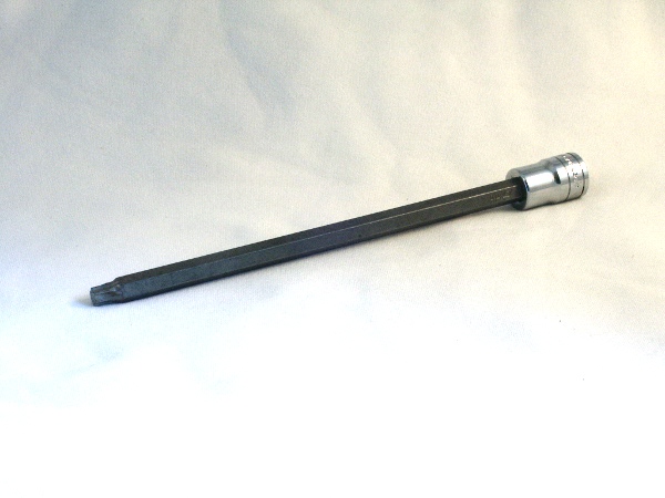 Long black Torx bit socket with chrome drive end on white cloth background