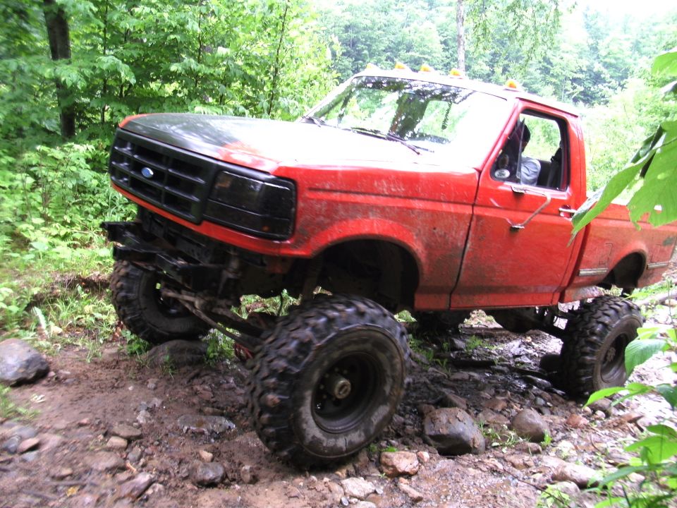 1994 Ford F-250 off-roading on a muddy trail