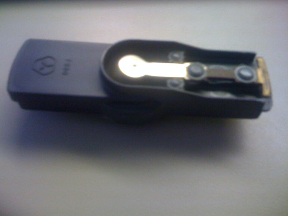 Distributor rotor with metal contact and two screws visible