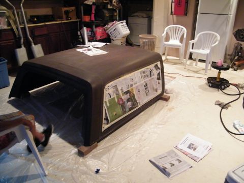 1982 Ford Bronco - A vehicle hard top is prepped for painting, with newspaper covering the window areas.