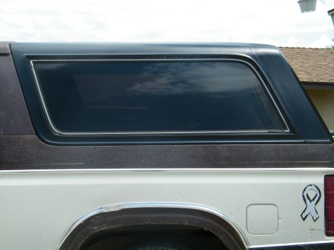 1982 Ford Bronco - The side profile of a 1982 Ford Bronco shows its distinctive hardtop and tinted rear window.