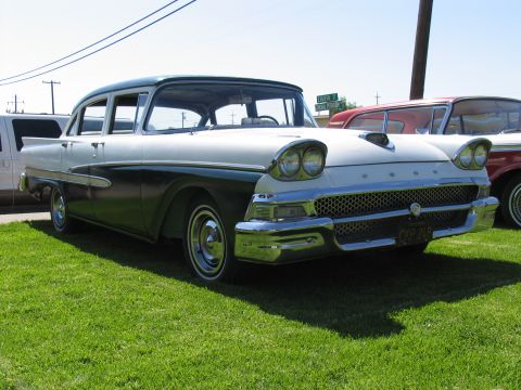 1984 Ford Bronco - Two-tone 1957 Ford Fairlane 500 sedan with chrome grille and dual headlights.