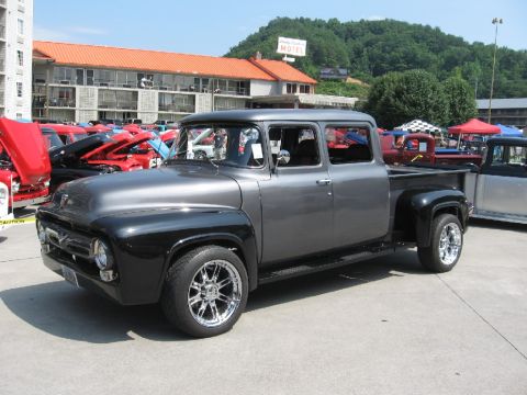 1966 Ford F-100 - This custom two-tone gray and black Ford F-100 crew cab pickup truck is on display at a car show.
