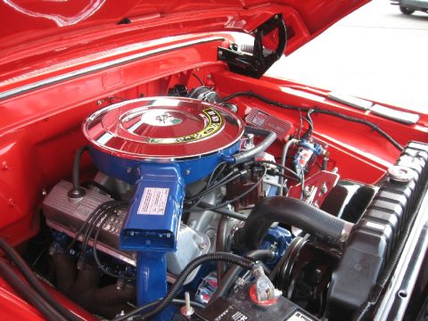 1966 Ford F-100 - The engine bay of a classic vehicle, a prominent air filter and radiator.
