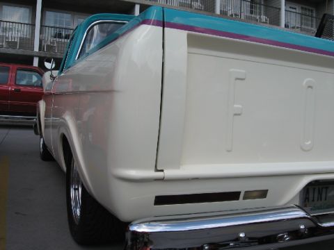 1966 Ford F-100 - White 1965 Ford F-100 pickup truck with a two-tone cab roof is parked next to a red SUV.