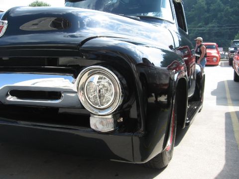 1966 Ford F-100 - A black 1953 Ford F-100 pickup truck is parked outdoors with other vehicles visible.