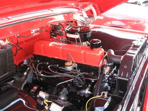 1966 Ford F-100 - Engine bay of a 1966 Ford F-100, showing the V8 engine with red valve covers.