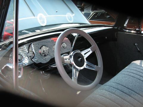 1966 Ford F-100 - View of a classic truck's interior, showing the steering wheel, dashboard, and seats.