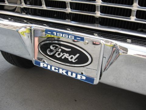 1966 Ford F-100 - Close-up of a 1966 Ford pickup truck's front end, showing the grille and bumper.