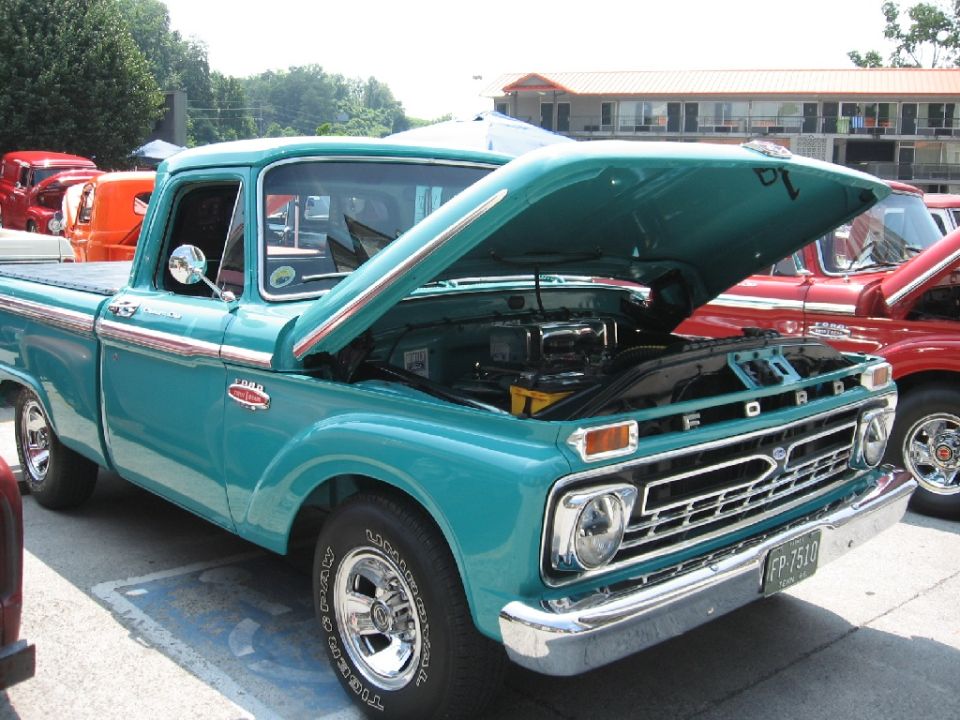 Teal 1966 Ford F-100 pickup truck, hood open, showing engine. License plate FP-7510